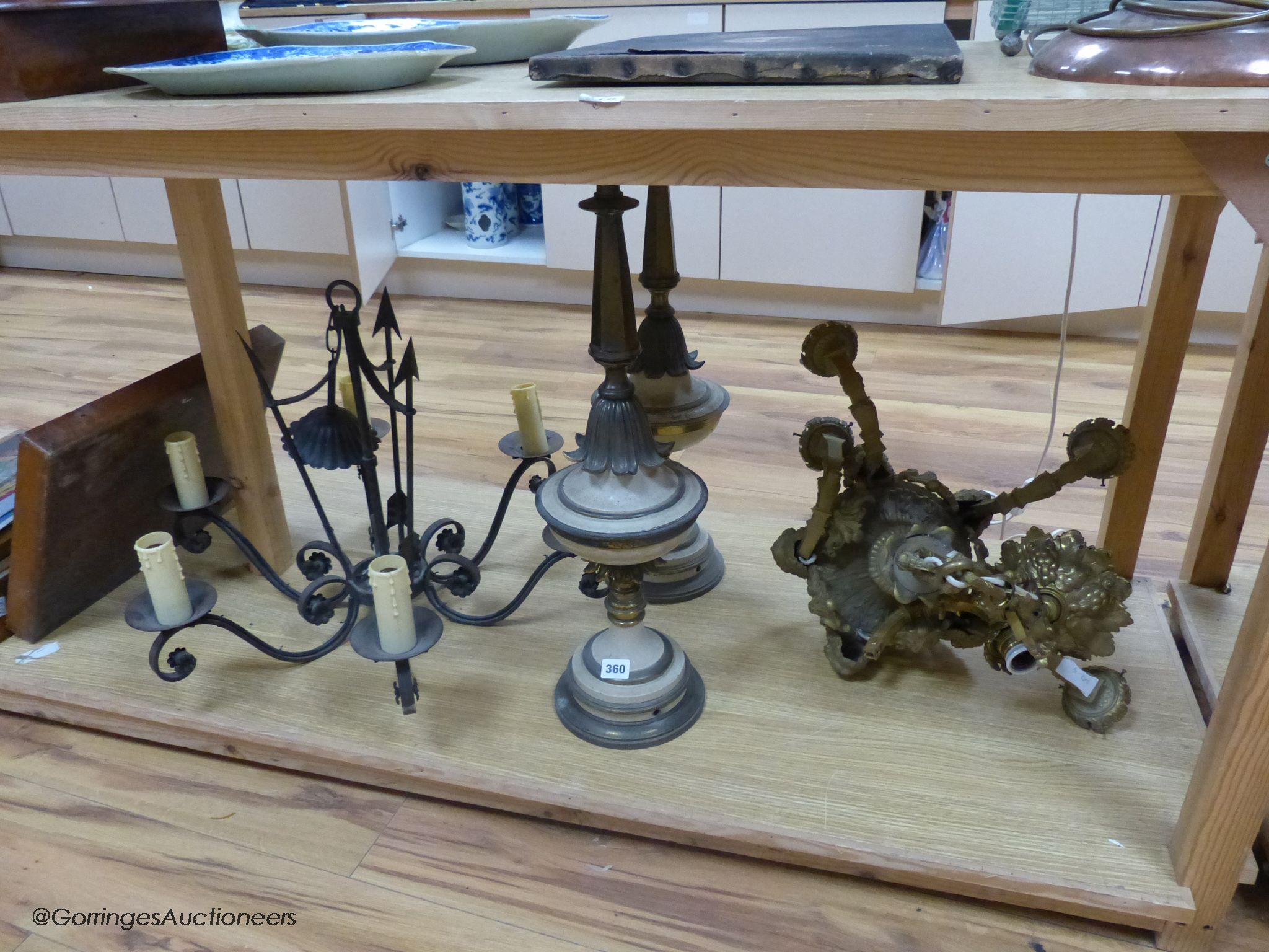 A cast brass electrolier, an ironwork exampleband a pair of table lamps